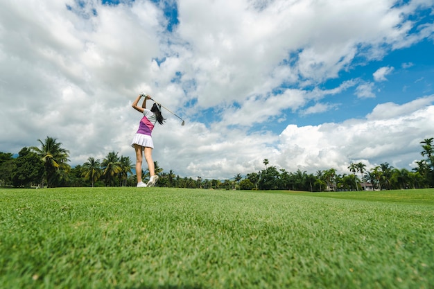 Jogador de golfe feminino jogando golfe no campo de golfe profissional