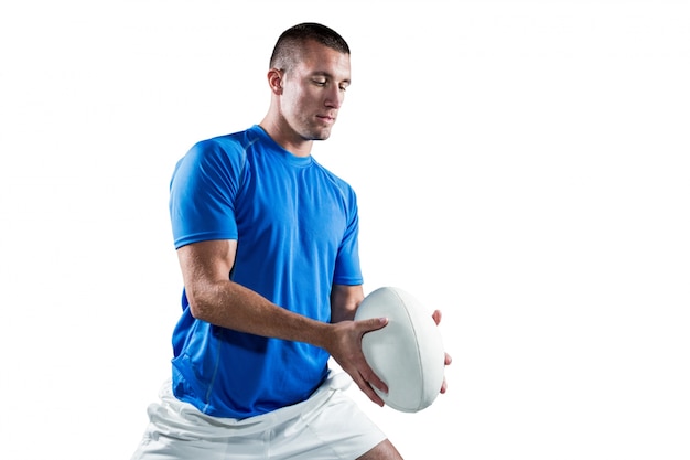 Foto jogador de rugby em jersey azul com bola
