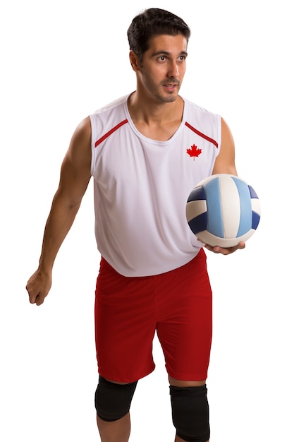 Jogador profissional de voleibol canadense com bola. Isolado no espaço em branco.