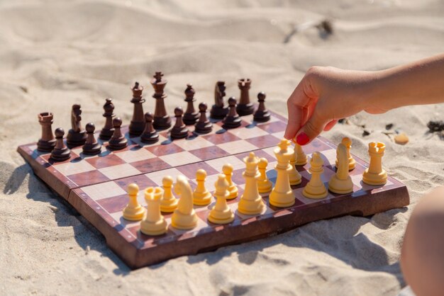 Jogo de xadrez no tabuleiro na praia, tabuleiro de xadrez na areia em um dia ensolarado.