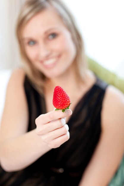 Jolly mulher comendo um morango