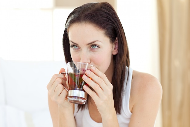 Jolly woman drinking tea