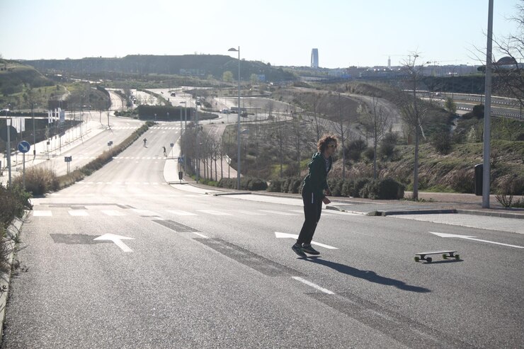 Foto jovem a andar de skate na estrada da cidade