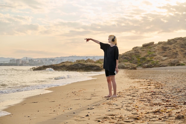 Foto jovem adolescente na praia pela manhã