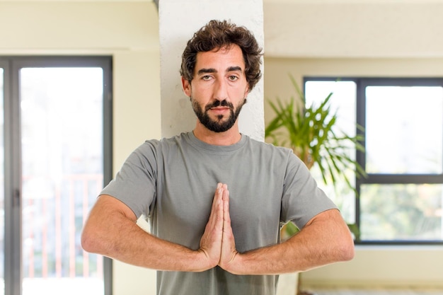 Jovem adulto louco com pose expressiva no interior de uma casa moderna