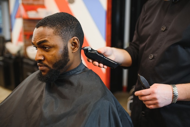 Jovem africano cortando cabelo na barbearia