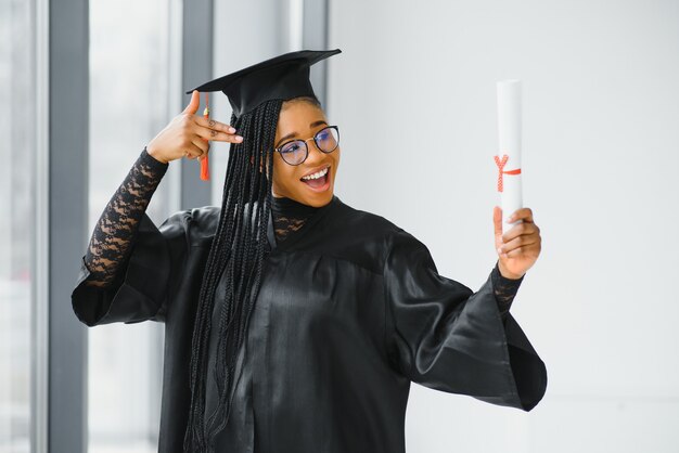 Jovem aluna de manto comemorando sua formatura