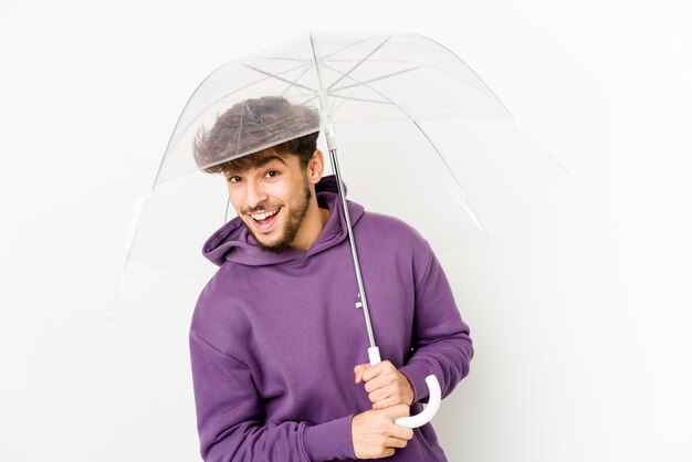Jovem árabe segurando um guarda-chuva, rindo e se divertindo.