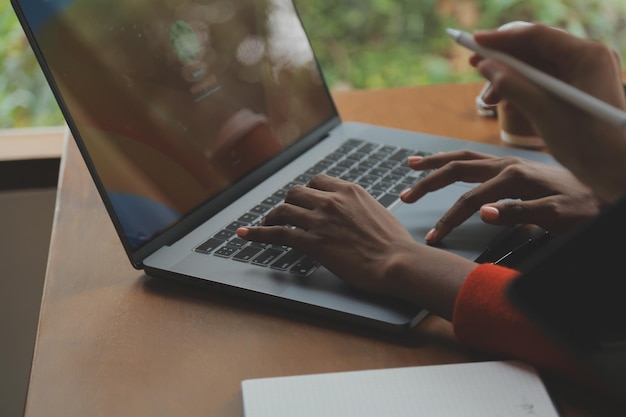 Jovem asiática criativa trabalhando no laptop em seu estúdio