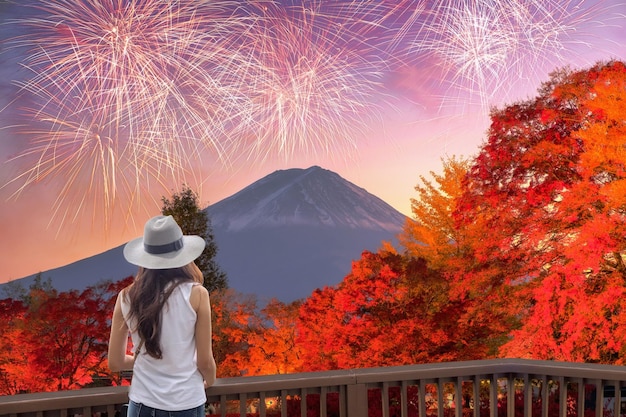 Jovem asiática visitando Fujisan com celebração de fogos de artifício na temporada de outono