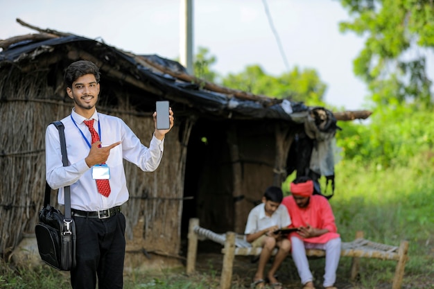 Jovem banco indiano mostrando tela do celular com fazendeiro