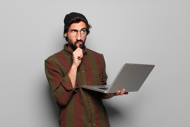 Jovem barbudo com um laptop