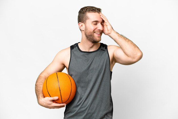 Jovem bonito jogando basquete sobre fundo branco isolado sorrindo muito