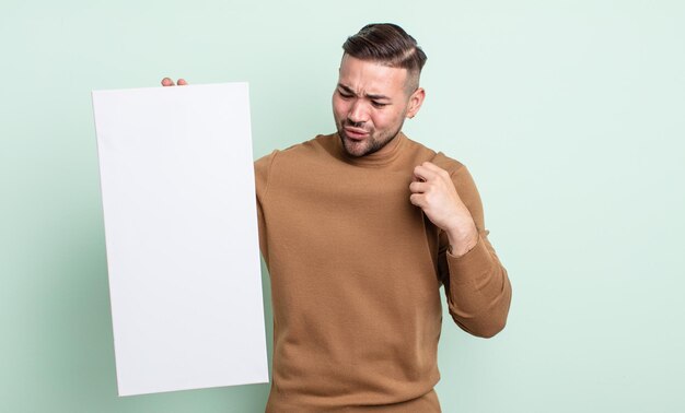 Jovem bonito se sentindo estressado, ansioso, cansado e frustrado. conceito de tela vazia