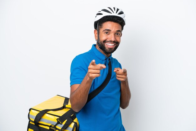 Jovem brasileiro com mochila térmica isolada no fundo branco, apontando para a frente e sorrindo