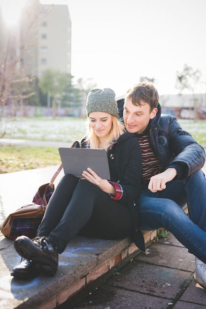 jovem casal amantes autêntico usando o tablet