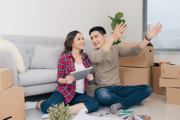 Jovem casal apaixonado, mudando-se para uma casa nova. Conceito de casa e família.