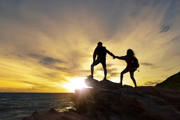 Jovem casal asiático escalando