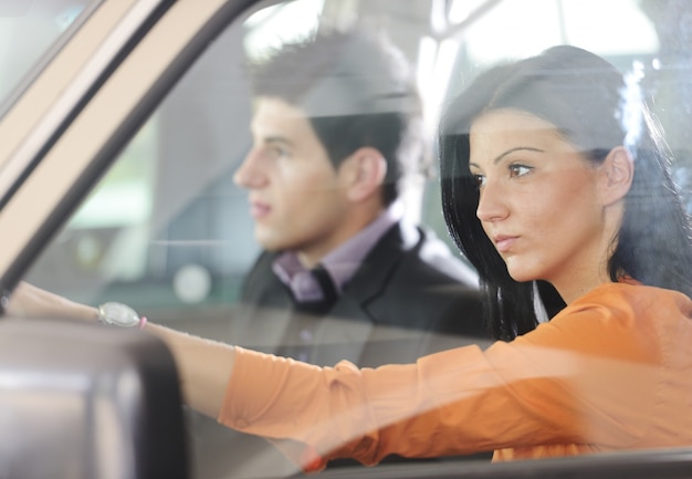 Jovem casal atraente dirigindo em um carro