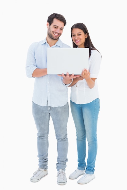 Jovem casal atraente segurando seu laptop