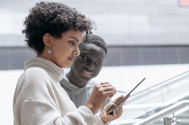 Jovem casal com um tablet digital no metrô