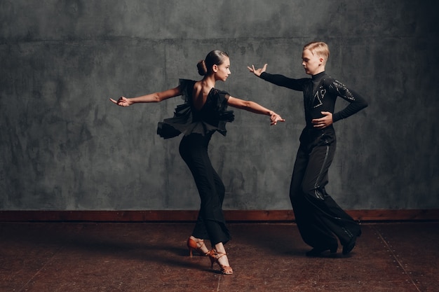 Jovem casal dançando na dança de salão cha cha cha.