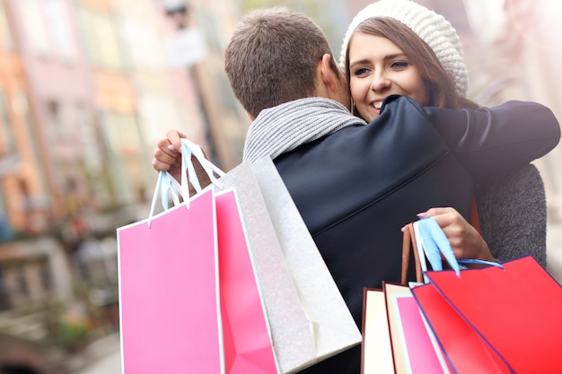 Foto jovem casal fazendo compras na cidade