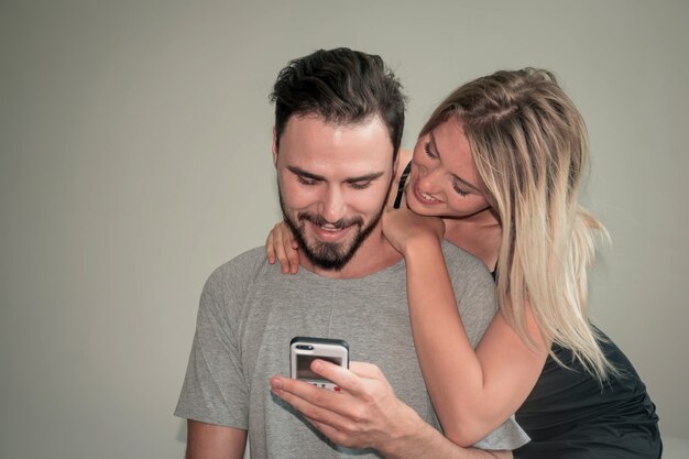 Jovem casal feliz olhando para o telefone