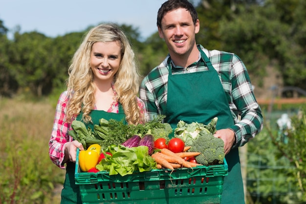 Jovem casal orgulhoso mostrando vegetais