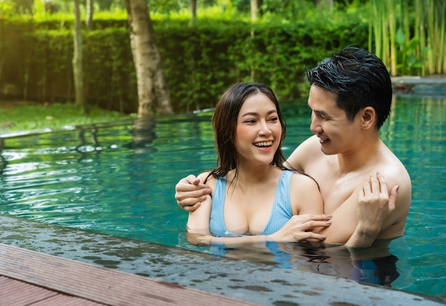 Jovem casal se divertindo na piscina