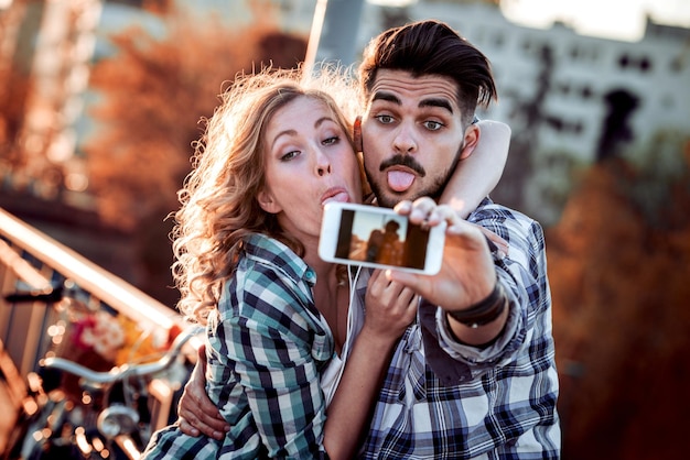 Jovem casal tira selfie na cidade