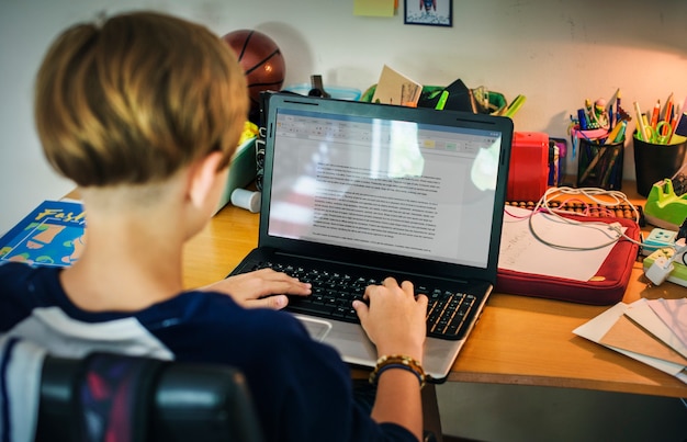 Jovem, caucasiano, menino, fazendo, dever casa, com, computador, laptop