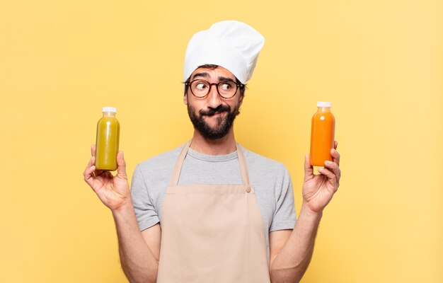 Jovem chef barbudo duvidando ou expressão incerta e segurando um sorriso