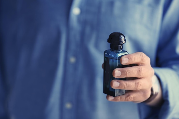 Foto jovem com frasco de perfume closeup