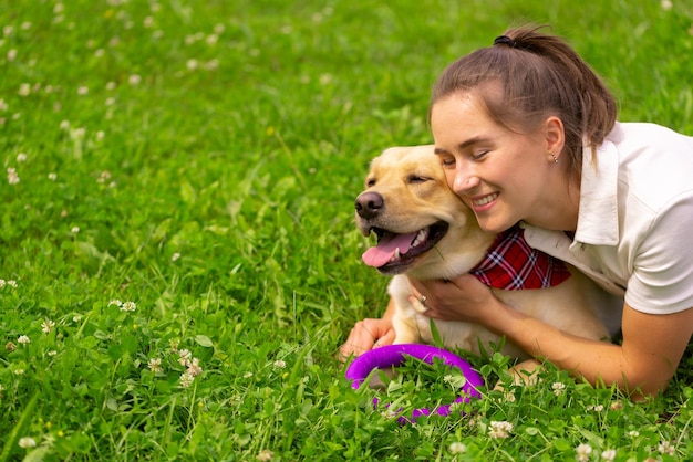 Jovem com seu lindo labrador amarelo fora do adorável conceito de amor animal de estimação