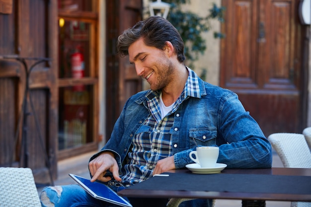 Jovem com tablet pc toque em um café