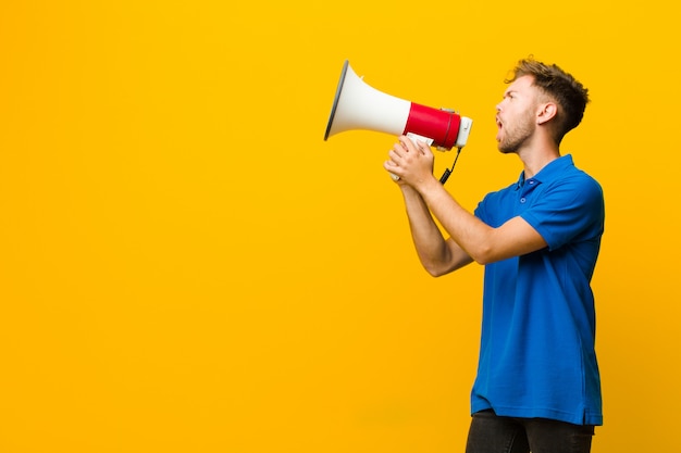 Jovem com um megafone em amarelo