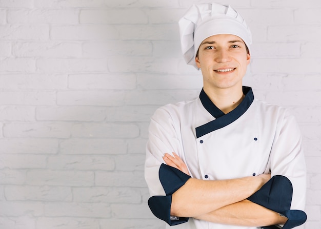 Jovem cozinheiro cruzando os braços no peito