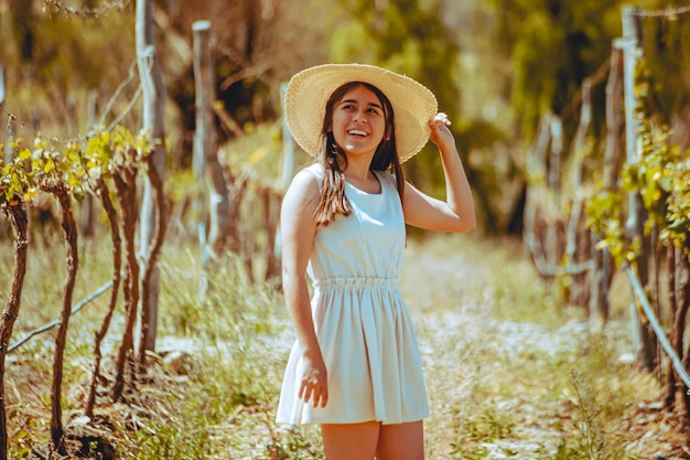 Jovem de vestido posando no parque