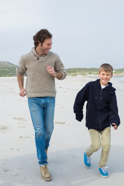 Jovem e filho jogging na praia