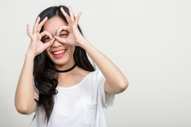 Jovem e linda mulher asiática contra o espaço em branco