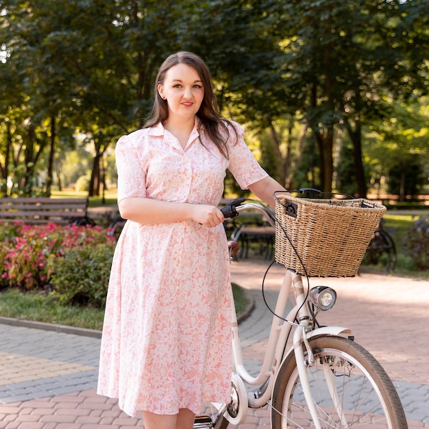 Foto jovem elegante posando com uma bicicleta