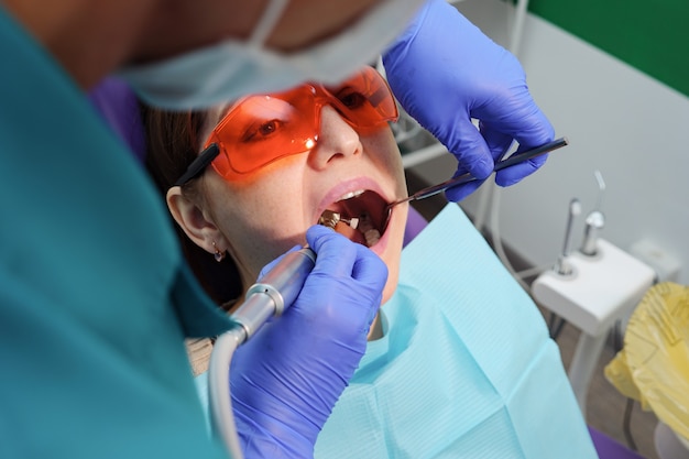 Jovem em exame preventivo na cadeira odontológica do dentista. Conceito de cuidados com os dentes.