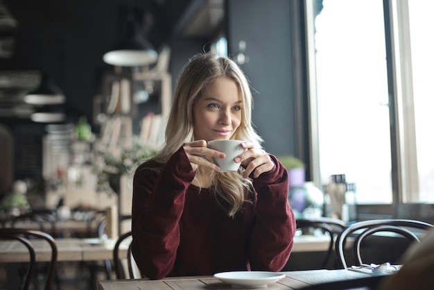 jovem em um café bebe café