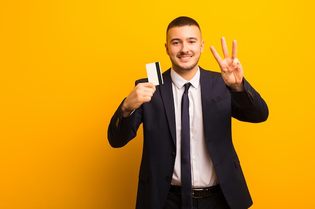 Jovem empresário bonitão contra o conceito de dinheiro de fundo liso