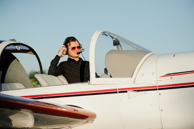 Jovem empresário bonitão dentro de um avião particular