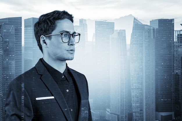 Jovem empresário bonito de terno e óculos sonhando com novas oportunidades de carreira após a graduação do MBA Cingapura em segundo plano Dupla exposição