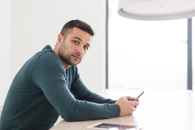 Jovem empresário casual usando smartphone no escritório de inicialização