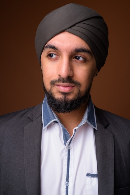 Jovem empresário sikh indiano barbudo usando turbante