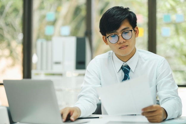 Foto jovem empresário trabalha usando laptop